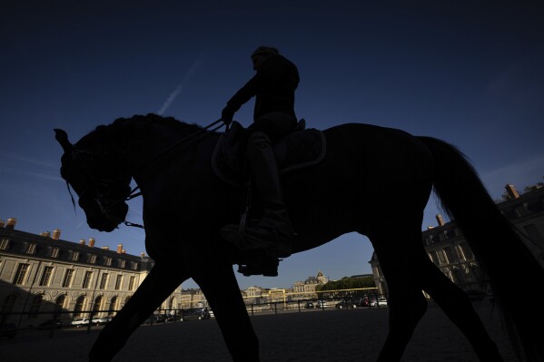 A horsewoman trains with her horse in the main courtyard of the royal stables, in Versailles, Thursday, April 25, 2024. More than 340 years after the royal stables were built under the reign of France's Sun King, riders and horses continue to train and perform in front of the Versailles Palace. The site will soon keep on with the tradition by hosting the equestrian sports during the Paris Olympics. Commissioned by King Louis XIV, the stables have been built from 1679 to 1682 opposite to the palace's main entrance. (Ǻ Photo/Aurelien Morissard)