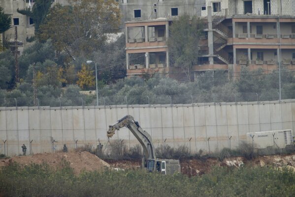 
              Israeli military digger works on the border with Lebanon in the northern Israeli town of Metula, Tuesday, Dec. 4, 2018. The Israeli military launched an operation on Tuesday to "expose and thwart" tunnels built by the Hezbollah militant group it says stretch from Lebanon into northern Israel. (AP Photo/Ariel Schalit)
            
