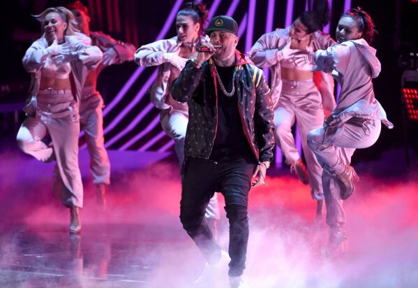 FILE - Nicky Jam performs "El Amante" at the 18th annual Latin Grammy Awards in Las Vegas on Nov. 16, 2017.  The reggaeton star voices the animated character Butch, a tough alley cat, in the film "Tom & Jerry." (Photo by Chris Pizzello/Invision/AP, File)