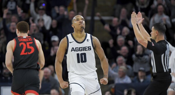 Utah State guard Darius Brown II (10) reacts after making a 3-pointer against San Diego State during the second half of an NCAA college basketball game Tuesday, Feb. 20, 2024, in Logan, Utah. (Eli Lucero/The Herald Journal via AP)