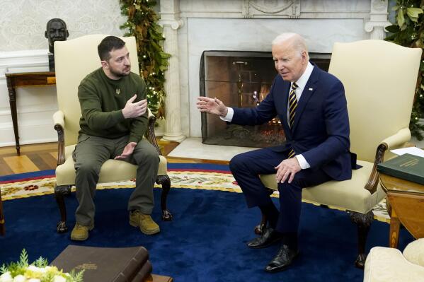 FILE - President Joe Biden speaks with Ukrainian President Volodymyr Zelenskyy as they meet in the Oval Office of the White House, Dec. 21, 2022, in Washington. Support among the American public for providing Ukraine weaponry and direct economic assistance has softened as the Russian invasion nears a grim one-year milestone. (AP Photo/Patrick Semansky, File)