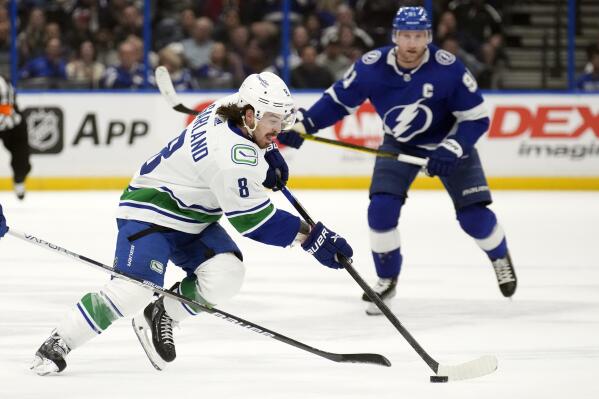 Vancouver Canucks right wing Conor Garland (8) cuts in front of Tampa Bay Lightning center Steven Stamkos (91) during the first period of an NHL hockey game Thursday, Jan. 12, 2023, in Tampa, Fla. (AP Photo/Chris O'Meara)
