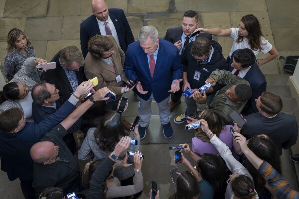 FILE - Speaker of the House Kevin McCarthy, R-Calif., is surrounded by reporters looking for updates on plans to fund the government and avert a shutdown, at the Capitol in Washington, Friday, Sept. 22, 2023. (AP Photo/J. Scott Applewhite, File)