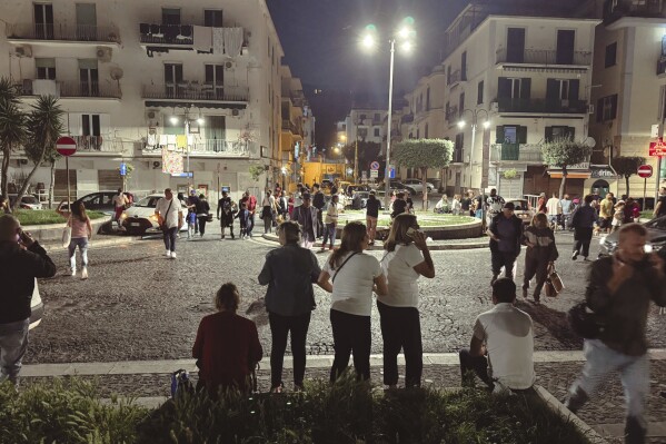 People gather in a street after an earthquake in Campi Flegrei, near Naples, Italy, Monday, May 20, 2024. The quake is the strongest ever recorded around the Phlegraean Fields, a sprawling area of ancient volcanic centers near the Tyrrhenian Sea that encompasses western neighborhoods of Naples and its suburbs, said Giuseppe De Natale, a vulcanologist of Italy’s INGV national geophysics and vulcanology center. (Alessandro Garofalo/LaPresse via AP)