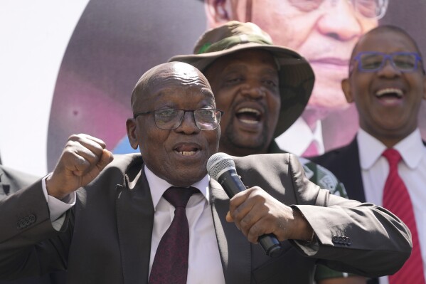 FILE — Former South African president, Jacob Zuma, sings and dances after addressing his supporters of the UMkhonto WeSizwe, (MK) party outside the High court in Johannesburg, South Africa, Thursday, April 11, 2024. For the first time since 1994, the ruling African National Congress (ANC) might receive less than 50% of votes after Zuma stepped down in disgrace in 2018 amid a swirl of corruption allegations and has given his support to the newly-formed MK. (AP Photo/Themba Hadebe/File)