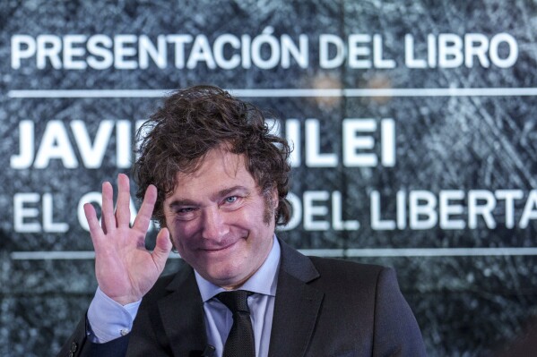 Argentina's President Javier Milei gestures as he presents his book 