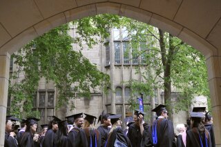 FILE - In this May 24, 2010 file photo, future graduates wait for the procession to begin for commencement at Yale University in New Haven, Conn. The Biden Justice Department says it is dismissing its discrimination lawsuit against Yale University. The Trump administration alleged last year that the university was illegally discriminating against Asian American and white applicants. On Feb. 3, 2021, the Justice Department noted in its filing that it was voluntarily dismissing the action. (AP Photo/Jessica Hill, File)