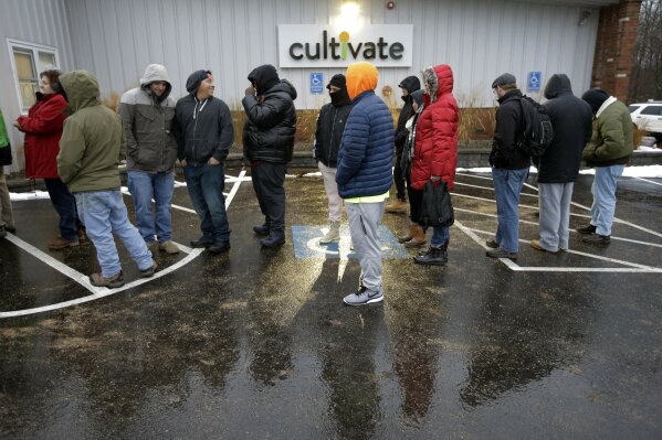 Customers wait outside the Cultivate cannabis dispensary to purchase recreational marijuana on the first day of legal sales, Tuesday, Nov. 20, 2018, in Leicester, Mass. Cultivate is one of the first two shops permitted to sell recreational marijuana in the eastern United States, opening more than two years after Massachusetts voters approved it in 2016. (AP Photo/Steven Senne)