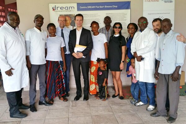 The Italian ambassador to Congo, Luca Attanasio, center, 5h from left, and his wife Zakia Seddiki, 5th from right, pose for a photo during a visit to the Sant'Egidio Community Dream center in Kinshasa, Congo, on Jan. 24, 2018. The Italian ambassador to Congo, an Italian carabineri police officer and their Congolese driver were killed Monday in an attack on a U.N. convoy in an area that is home to myriad rebel groups, the Foreign Ministry and local people said. Luca Attanasio, Italy's ambassador to the country since 2017, carabinieri officer Vittorio Iacovacci and their driver were killed. Other members of the convoy were injured, WFP said. (Comunita' di Sant'Egidio via AP)