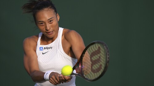 China's Zheng Qinwen returns to Czech Republic's Katerina Siniakova in a first round women's singles match on day one of the Wimbledon tennis championships in London, Monday, July 3, 2023. (AP Photo/Alberto Pezzali)