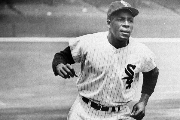 FILE - Minnie Minoso, Chicago White Sox outfielder, practices running the bases at Comiskey Park in Chicago, June 1, 1955. Minosa will be posthumously inducted into the Baseball Hall of Fame on Sunday, July 24, 2022. Major League Baseball said Tuesday, May 28, 2024, that it has incorporated records for more than 2,300 Negro Leagues players following a three-year research project. Miñoso was credited with 150 hits with the New York Cubans of the second Negro National League from 1946-1948, raising his total to 2,113. (AP Photo/File)