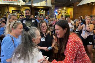 FILE - Former White House press secretary Sarah Sanders, right, greets supporters at an event for her campaign for governor at a Colton's Steak House on Sept. 10, 2021, in Cabot, Ark. Arkansas Gov. Asa Hutchinson on Friday, Nov. 12, 2021, endorsed Sarah Sanders' bid to succeed him as governor, days after the former White House press secretary's path to the Republican nomination was cleared. (AP Photo/Andrew DeMillo, File)