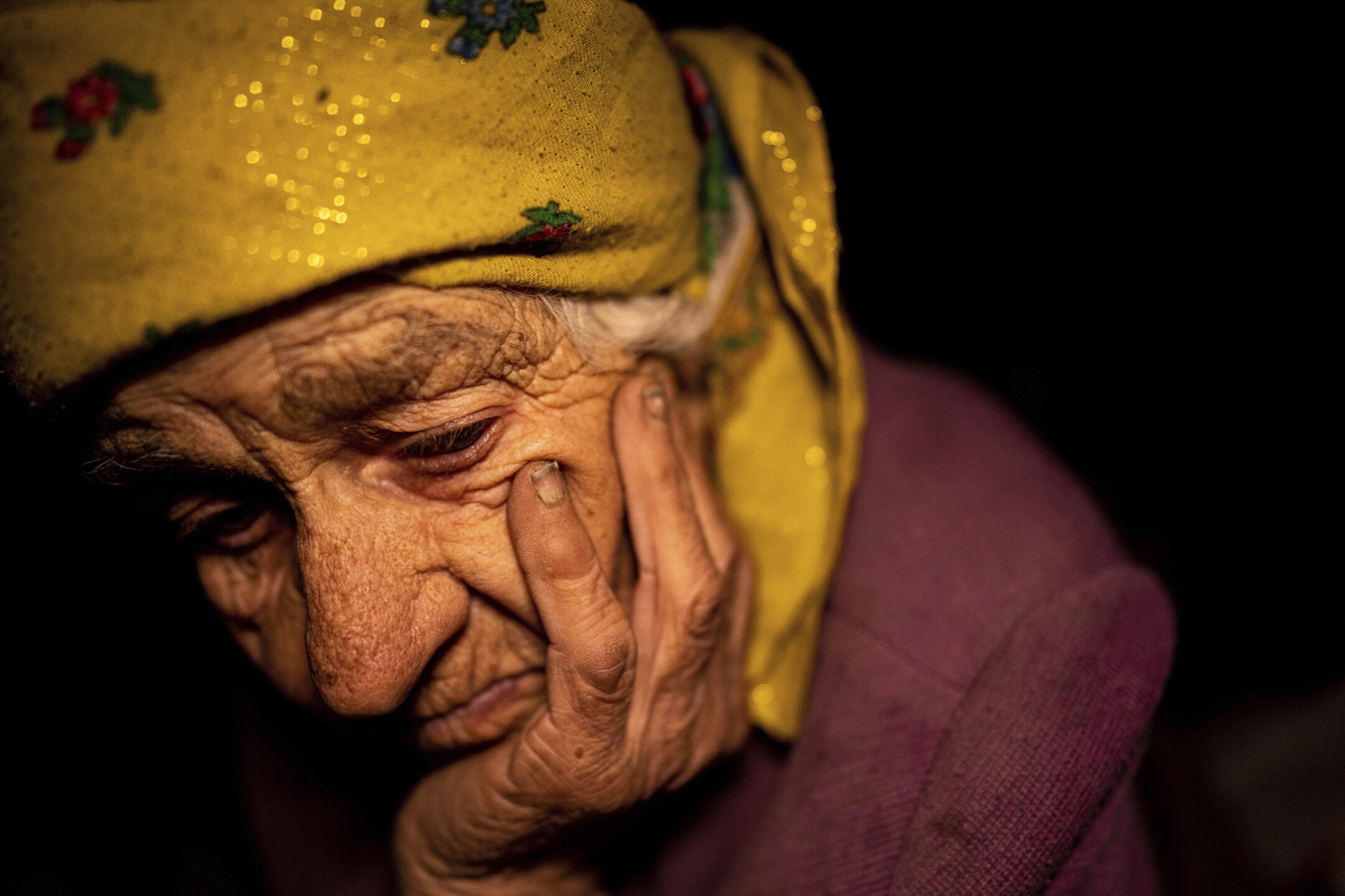 Nina Gonchar, 93, sits in her house, which was mostly destroyed by Russian forces, in the village of Bogorodychne, Ukraine, on Jan. 7, 2023, shortly after the village was retaken by the Ukrainian army. Gonchar's son Vasyliy and his wife Liubov were killed by Russian shelling on July 10, 2022. (AP Photo/Evgeniy Maloletka)