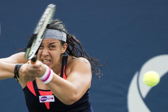 Marion Bartoli, of France, returns the ball against Magdalena Rybarikova, of Slovakia, during the Rogers Cup women's tennis tournament Thursday, Aug. 8, 2013, in Toronto. (AP Photo/The Canadian Press, Nathan Denette)