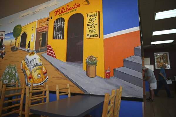 A mural is displayed at a fast-food Mexican restaurant near the Deer Valley suburb in Phoenix, Ariz., on March 9, 2020. Suburbs across the country have grown more diverse, crowded and politically competitive. These trends are eating away at decades of Republican control as more than half of the electorate calls the suburbs home. (AP Photo/Dario Lopez-MIlls)
