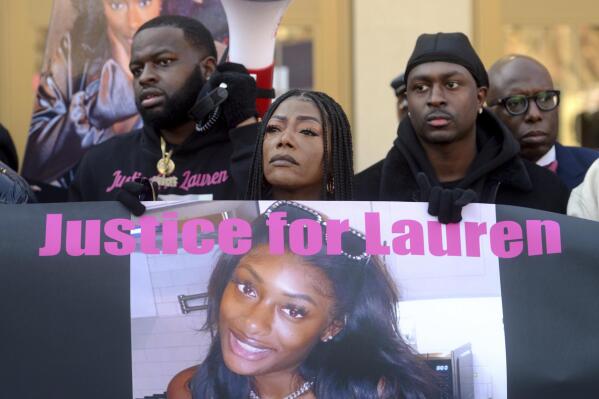 Shantell Fields, Lauren Smith-Fields' mother, stands with family members during a protest rally in front of the Morton Government Center, in Bridgeport, Conn. Jan. 23, 2022. Smith-Fields was found dead in her Bridgeport apartment in December and her family and friends marched in her memory on Sunday, which would have been her 24th birthday. The death of the Black women has her family and the community asking questions about policing, race and victims rights. (Ned Gerard/Hearst Connecticut Media via AP)
