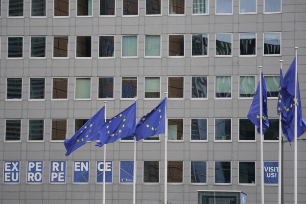 European Union flags flap in the wind in the EU Quarter of Brussels, Wednesday, Sept. 20, 2023. The European Quarter is the headquarters of the main buildings of the European Union, inluding the European Parliament. (AP Photo/Virginia Mayo)