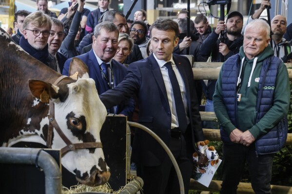 French President Emmanuel Macron visits the International Agriculture Fair on the opening day in Paris, Saturday, Feb. 24, 2024. Farmers across Europe have been protesting for weeks over what they say are excessively restrictive environmental rules. (Ludovic Marin/Pool via AP)