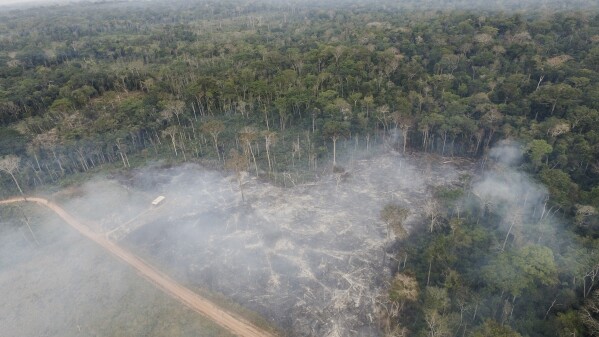 Smoke rises from recent fires in the Chico Mendes Extractive Reserve, in Xapuri, Acre state, Brazil, on Saturday, Sept. 23, 2023. President Luiz Inácio Lula da Silva, who’s been in office since January, has made significant strides in bringing down deforestation in the Amazon. Still, progress has not been enough to protect hundreds of forest communities from the advancement of cattle. (AP Photo/Gleilson Miranda)