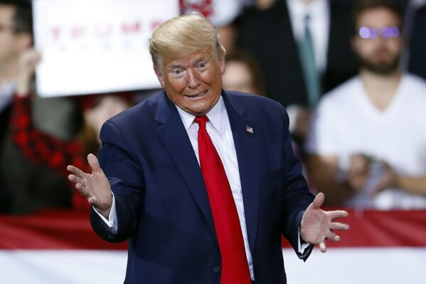 In this Dec. 18, 2019, photo, President Donald Trump speaks at a campaign rally in Battle Creek, Mich. Using stark “Us versus Them” language, Trump and his campaign are trying to frame impeachment not as judgment on his conduct but as a culture war referendum on him and his supporters, aiming to motivate his base heading into an election year (AP Photo/Paul Sancya)