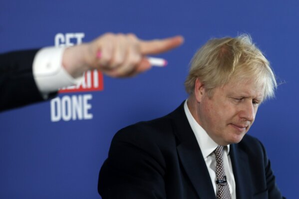Chancellor of the Duchy of Lancaster Michael Gove, left, gestures during a media conference with Britain's Prime Minister Boris Johnson, right, in London, Friday, Nov. 29, 2019. Britain goes to the polls on Dec. 12. (AP Photo/Frank Augstein)