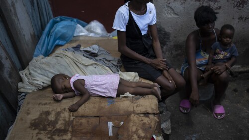 People displaced by gang violence from the area of Cite Soleil sit at a makeshift shelter in the Delmas neighborhood in Port-au-Prince, Haiti, Sunday, June 4, 2023. (AP Photo/Ariana Cubillos)