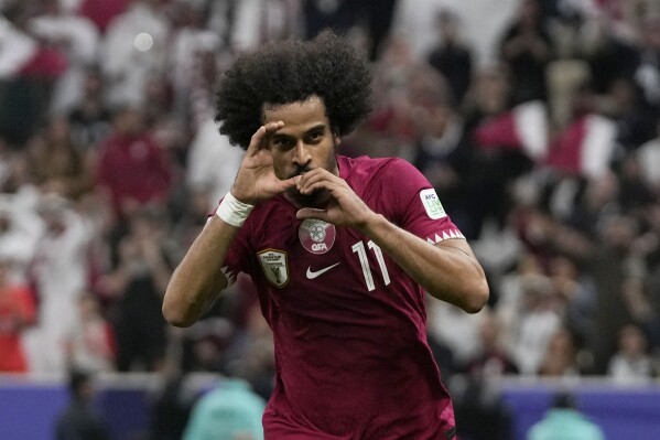 Qatar's Akram Afif celebrates after scoring the opening goal during the Asian Cup Group A soccer match between Qatar and Lebanon at the Lusail Stadium in Lusail, Qatar, Friday, Jan. 12, 2024. (AP Photo/Thanassis Stavrakis)