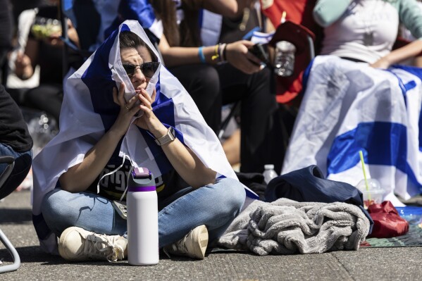 Residents and friends gather in Huyler Park ahead of the release of American hostage Edan Alexander from Hamas on Monday, May 12, 2025, in Tenafly, N.J. (AP Photo/Stefan Jeremiah)