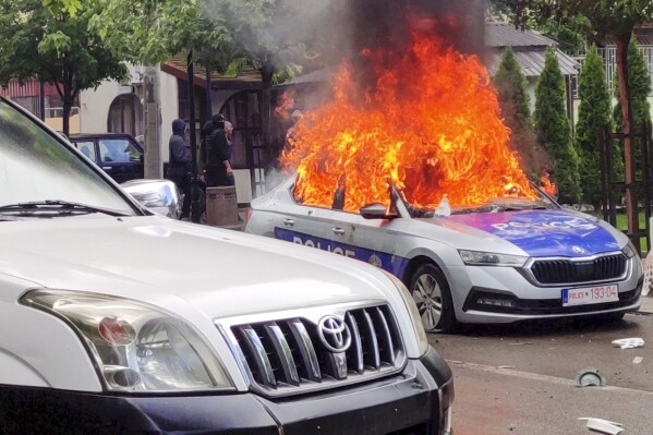 FILE - In this image made from video, Kosovar police car burns in Zvecan, northern Kosovo on May 26, 2023. The European Union has summoned the leaders of Serbia and Kosovo for emergency talks on Thursday June 22, 2023 to try to bring an end to a series of violent clashes near their border that is fueling fears of a return to open conflict. (AP Photo, File)