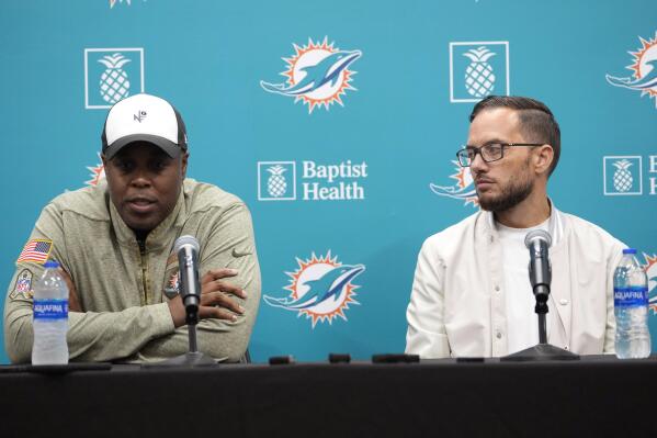 Miami Dolphins general manager Chris Grier , left, and head coach Mike McDaniel, right, speaks at a news conference during the NFL football draft Saturday, April 29, 2023, at the football team's training center in Miami Gardens, Fla. (AP Photo/Lynne Sladky)