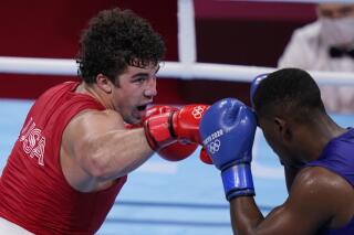 FILE - Richard Torrez Jr., from the United States, left, exchanges punches with Cuba's Dainier Pero during their men's super heavyweight over 91-kg boxing match at the 2020 Summer Olympics, Aug. 1, 2021, in Tokyo, Japan. American and British boxing officials have on Thursday, April 13, 2023 launched a breakaway group with the aim of saving boxing’s place at the Olympics, to be called World Boxing. Lauren Price of Britain, a gold medalist at the Tokyo Olympics in 2021, and silver medalist Richard Torrez Jr. of the United States are on the board as athlete representatives. (AP Photo/Frank Franklin II, file)