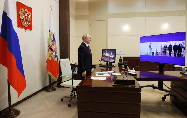 Russian President Vladimir Putin listens to the national anthem at a ceremony for the nuclear-powered icebreaker Ural and the launching of the icebreaker Yakutia, via videoconference, at his Novo-Ogaryovo state residence, outside Moscow, Tuesday, Nov. 22, 2022. Putin sent Russian forces into Ukraine on Feb. 24, 2022, and appears determined to prevail. (Mikhail Metzel/Pool Photo via AP, File)