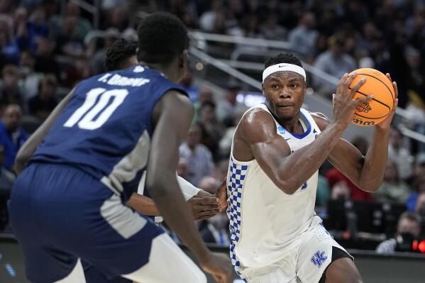 FILE - Kentucky forward Oscar Tshiebwe, right, drives to the basket ahead of Saint Peter's forward Fousseyni Drame (10) during the second half of a college basketball game in the first round of the NCAA tournament, Thursday, March 17, 2022, in Indianapolis. Tshiebwe was a unanimous selection to The Associated Press preseason All-America team, Monday, Oct. 24, 2022. (AP Photo/Darron Cummings, File)