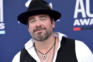 FILE - In this Sunday, April 7, 2019 file photo, Lee Brice arrives at the 54th annual Academy of Country Music Awards at the MGM Grand Garden Arena  in Las Vegas. Country singer Lee Brice tested positive for COVID-19 and will not perform as scheduled at the CMA Awards on Wednesday, Nov. 11, 2020.  (Photo by Jordan Strauss/Invision/AP)