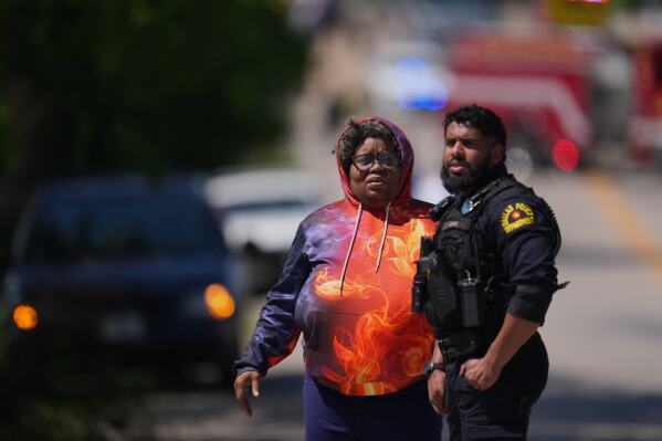 On Tuesday, April 15, 2025, a woman arrives at a checkpoint outside Wilmer Hutchins High School where police are responding to reports of a shooting in Dallas, Texas.