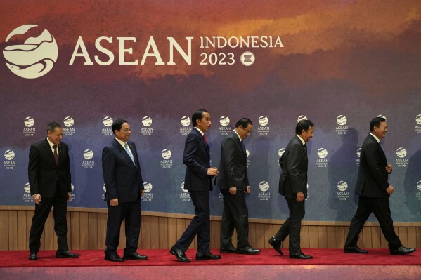 From left to right, Thailand's Permanent Secretary of the Ministry of Foreign Affairs Sarun Charoensuwan, Vietnam's Prime Minister Pham Minh Chinh, Indonesian President Joko Widodo, Laotian Prime Minister Sonexay Siphandone, Brunei's Sultan Hassanal Bolkiah and Cambodia's Prime Minister Hun Manet leave the stage after a group photo before the start of the retreat session at the Association of Southeast Asian Nations (ASEAN) Summit in Jakarta, Indonesia, Tuesday, Sept. 5, 2023. (AP Photo/Achmad Ibrahim, Pool)
