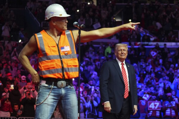 President-elect Donald Trump dances with The Village People at a rally ahead of the 60th Presidential Inauguration, Sunday, Jan. 19, 2025, in Washington. (AP Photo/Evan Vucci)