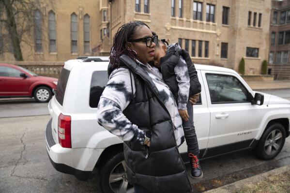 Chicago educator Tamisha Holifield spends time with her 2-year-old daughter Rian Holifield at Nichols Park, Thursday, Dec. 29, 2022, in the Hyde Park neighborhood of Chicago. When Holifield and her daughter had COVID-19 in May, the toddler had to miss 15 days of child care. Bouts of colds have followed in what Holifield described as a "constant whirlwind" of sickness that has been stressful both financially and emotionally. "It's a major inconvenience. But I'm a single parent, so I don't have a choice. If I drop the ball, the game is over," Holifield said. (AP Photo/Erin Hooley)