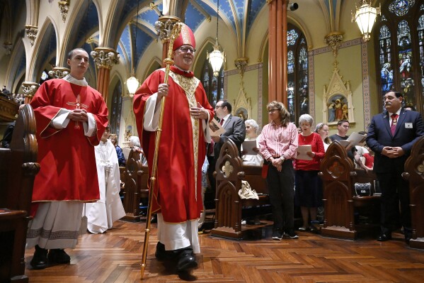 The Most Rev. Christopher J. Coyne, archbishop of Hartford, walks in a procession during a Pentecost Vigil at Blessed Michael McGivney Parish in St. Mary's Church, Saturday, May 18, 2024, in New Haven, Conn. The Eucharistic Procession from St. Mary's Church is one of four pilgrimage routes crossing the country and converging at the National Eucharistic Congress in Indianapolis on July 16. (AP Photo/Jessica Hill)