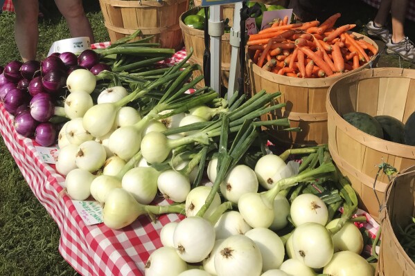 Various vegetables are displayed for sale at a farmer's market in Waitsfield, Vt., on Aug. 28, 2021. Signing up for a Community-Supported Agriculture program means getting a box of produce from local farms every week or two. It's a great way to take advantage of summer's bounty, discover new fruits and vegetables, and support the folks who grow food in your area. (AP Photo/Carolyn Lessard)