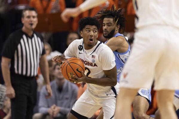Virginia's Reece Beekman (2) defends the ball against North Carolina during the first half of an NCAA college basketball game in Charlottesville, Va., Tuesday, Jan. 10, 2023. (AP Photo/Mike Kropf)