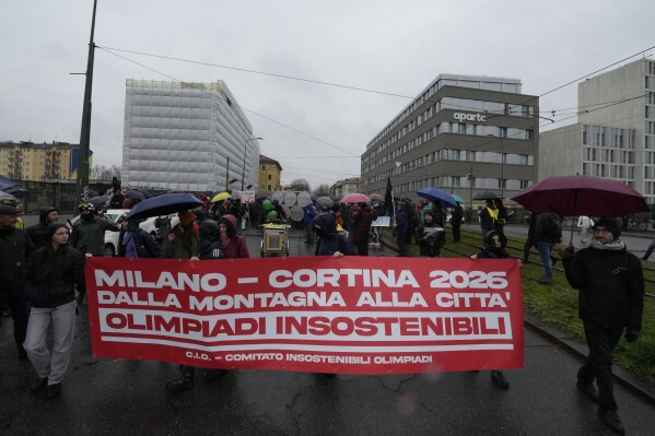 Activists of the C.I.O Comitato Insostenibili Olimpiadi (Unsustainable Olympics Commetee) show a banner in Italian reading: "Milano-Cortina 2026, from the mountains to the city, unsustainable Olympics", as they march in Milan, northern Italy, Saturday, Feb. 10, 2024, against the prospected costs of the 2026 Winter Olympics that will be disputed in Milan and Cortina d'Ampezzo in the Dolomites. (APPhoto/Luca Bruno)