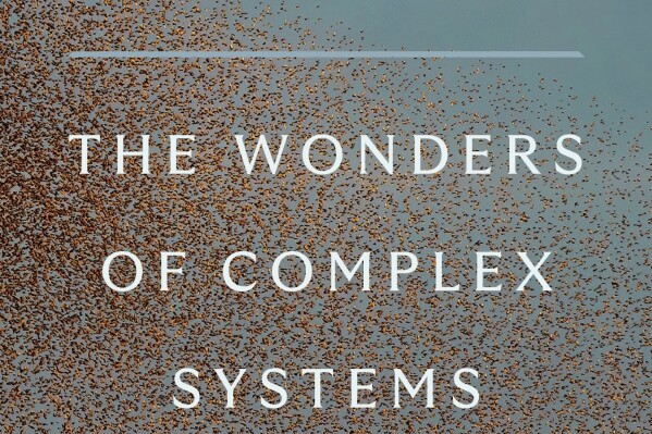 This cover image released by Penguin Press shows "In a Flight of Starlings: The Wonders of Complex Systems" by Giorgio Parisi. (Penguin Press via AP)