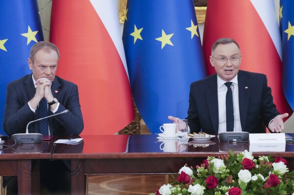 Poland's Prime Minister Donald Tusk, left, and President Andrzej Duda attend a meeting of the Cabinet Council, a consultation format between the president and the government, in Warsaw, Poland, on Tuesday Feb. 13, 2024. Tusk said Tuesday he has documentation proving that state authorities under the previous government used powerful Pegasus spyware illegally and that list of victims" was "very long ". (APPhoto/Czarek Sokolowski)