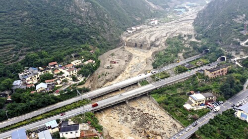 In this aerial photo released by China's Xinhua News Agency, a landslide site is seen in Miansi Township of Wenchuan County in southwestern China's Sichuan Province, Tuesday, June 27, 2023. Several people were found dead and others remained missing after landslides hit a county in China's southwestern Sichuan province on Tuesday, leading to authorities evacuating more than 900 people. (Xinhua via AP)