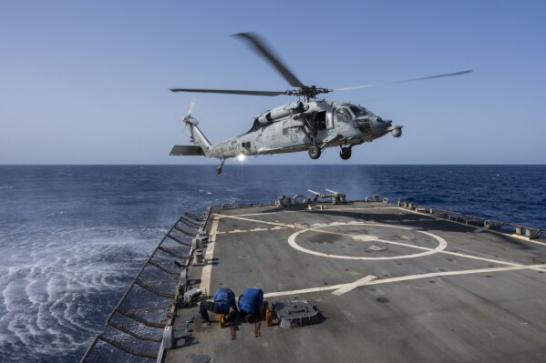 An HSC-7 helicopter lands on the Arleigh Burke-class guided missile destroyer USS Laboon in the Red Sea, Wednesday, June 12, 2024. (AP Photo/Bernat Armangue)