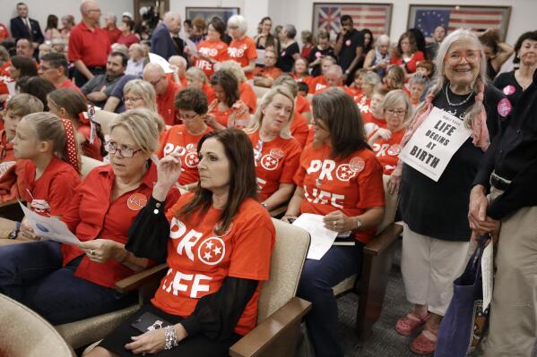 FILE - In this Aug. 12, 2019, file photo, people wait for a Senate hearing to begin to discuss a fetal heartbeat abortion ban, or possibly something more restrictive in Nashville, Tenn. The assertion by proponents that abortion as early as six weeks into pregnancy “stops a beating heart” was arguably the stroke of political genius that helped so-called “heartbeat bills” defy constitutional concerns to become law in 12 states. None has taken effect due to court challenges, the latest being argued Thursday, April 29, 2021, in Tennessee. (AP Photo/Mark Humphrey, File)