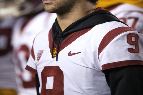Southern California quarterback Kedon Slovis (9), who is out with an injury, stands on the sideline during the second quarter of the team's NCAA college football game against California, Saturday, Dec. 4, 2021, in Berkeley, Calif. (AP Photo/D. Ross Cameron)