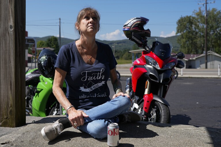 Karen Goodwin rests at a roadside market during a motorcycle ride along U.S. Highway 421, also known as The Snake, Friday, Sept. 22, 2023, in Shady Valley, Tenn. Goodwin’s son, Austin Hunter Turner, died in 2017 at the age of 23 after an encounter with the Bristol Police Department. (AP Photo/George Walker IV)