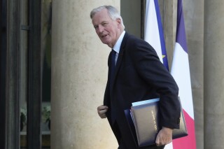 FILE - France's Prime Minister Michel Barnier arrives for a weekly cabinet meeting at the Elysee Palace, in Paris, Thursday, Oct. 10, 2024. (AP Photo/Michel Euler, File)